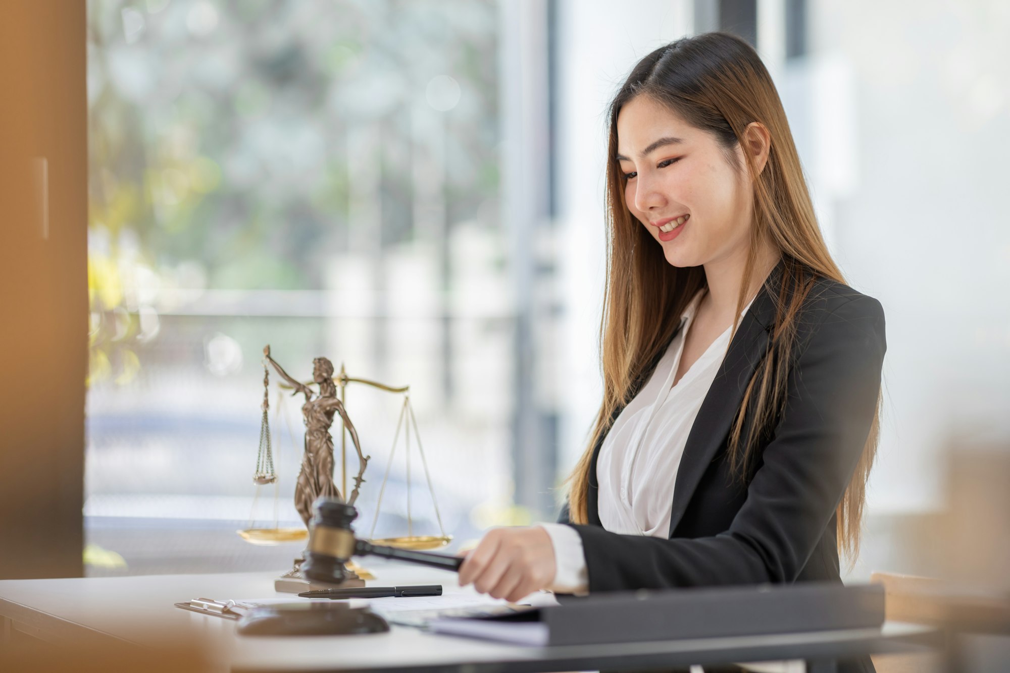 Attractive young lawyer in office Business woman and lawyers discussing contract papers with brass